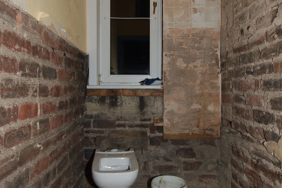 Bathroom renovation disruption before new finish Bathroom demolition / stripped renovation context showing disruption before finishing works