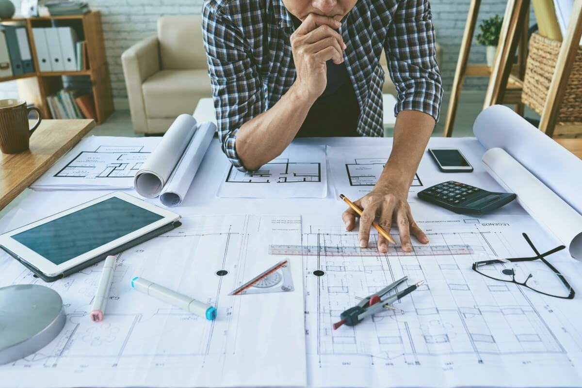 Illustration of a project planner reviewing drawings and calculations